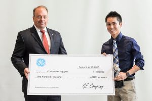 UW biomedical engineering undergraduate Chris Nguyen (right) receives a GE Unimpossible Missions Award during a ceremony held in Engineering Hall at the University of Wisconsin-Madison on Sept. 12, 2016. Nguyen will receive a scholarship of up to $100,000 and a 10-week paid internship at the GE Global Research Center in Niskayuna, New York. (Photo by Bryce Richter / UW-Madison)