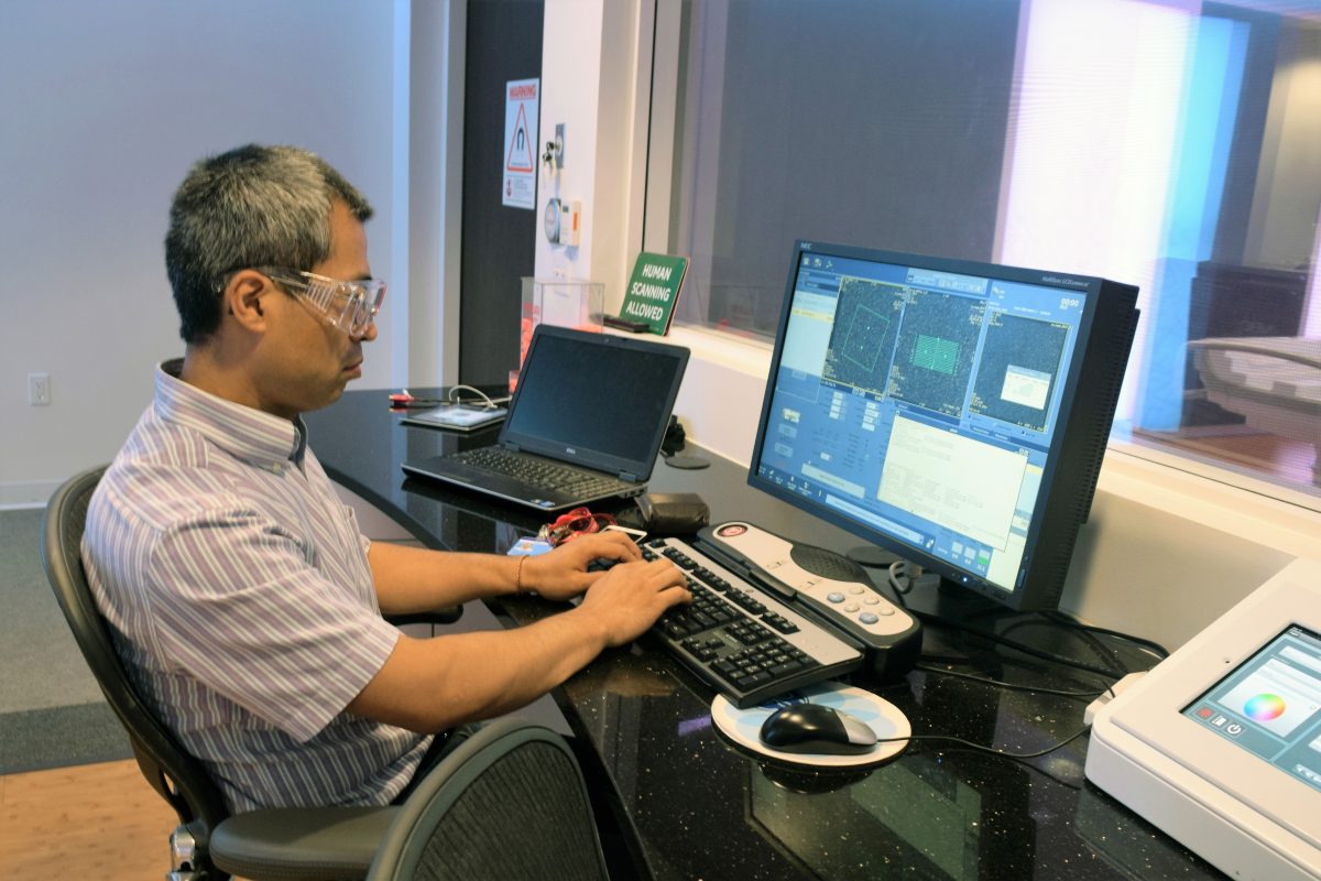 GE Researcher seated at a computer