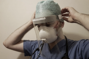 Health care worker wears face shield