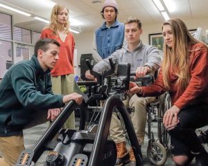 students and an adaptive rowing machine