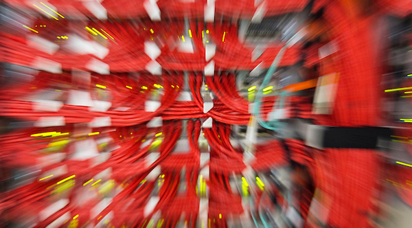 Bundles of orange data cables connect arrays of computer servers in the Space Science and Engineering Center (SSEC) Data Center at the Atmospheric, Oceanic and Space Sciences (AOSS) Building at the University of Wisconsin-Madison on Dec. 4, 2014. (Photo by Jeff Miller/UW-Madison)