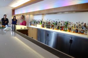 Long bar featuring different alcoholic bottles