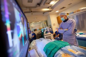 Photo: A man looks at a screen connected to medical equipment.