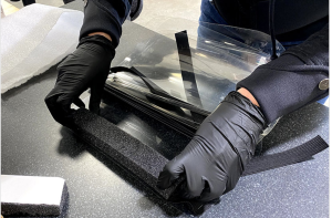 Worker assembles a face shield 