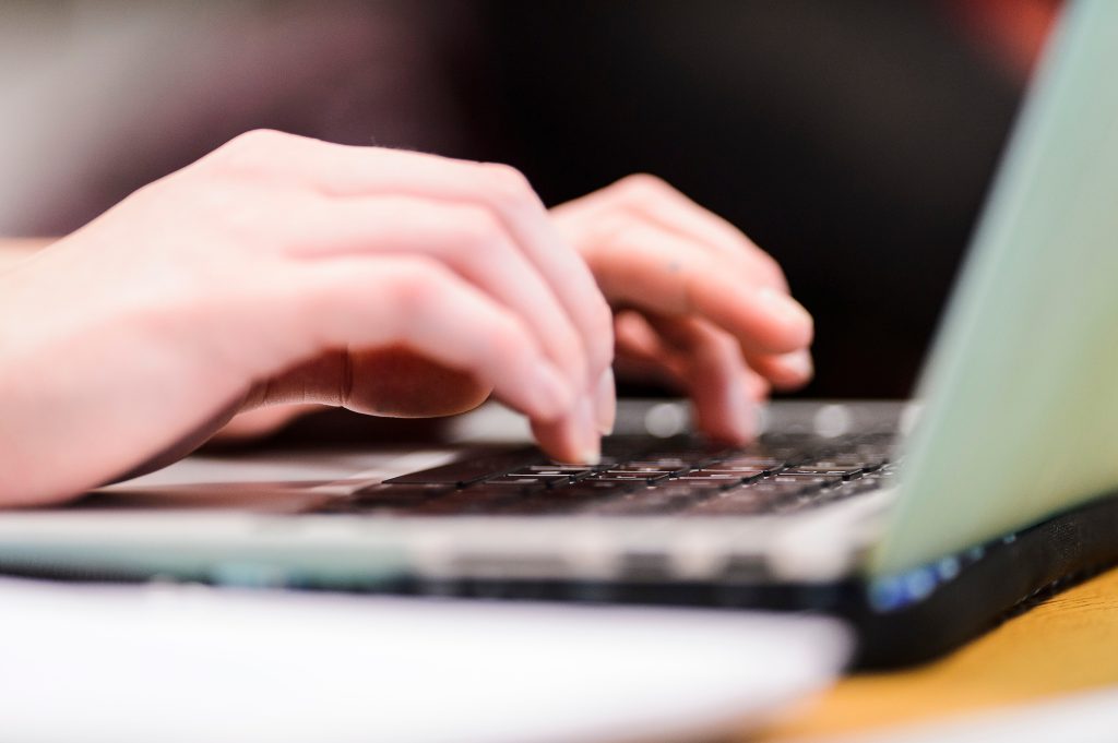 Image of a student's hands while working on a computer