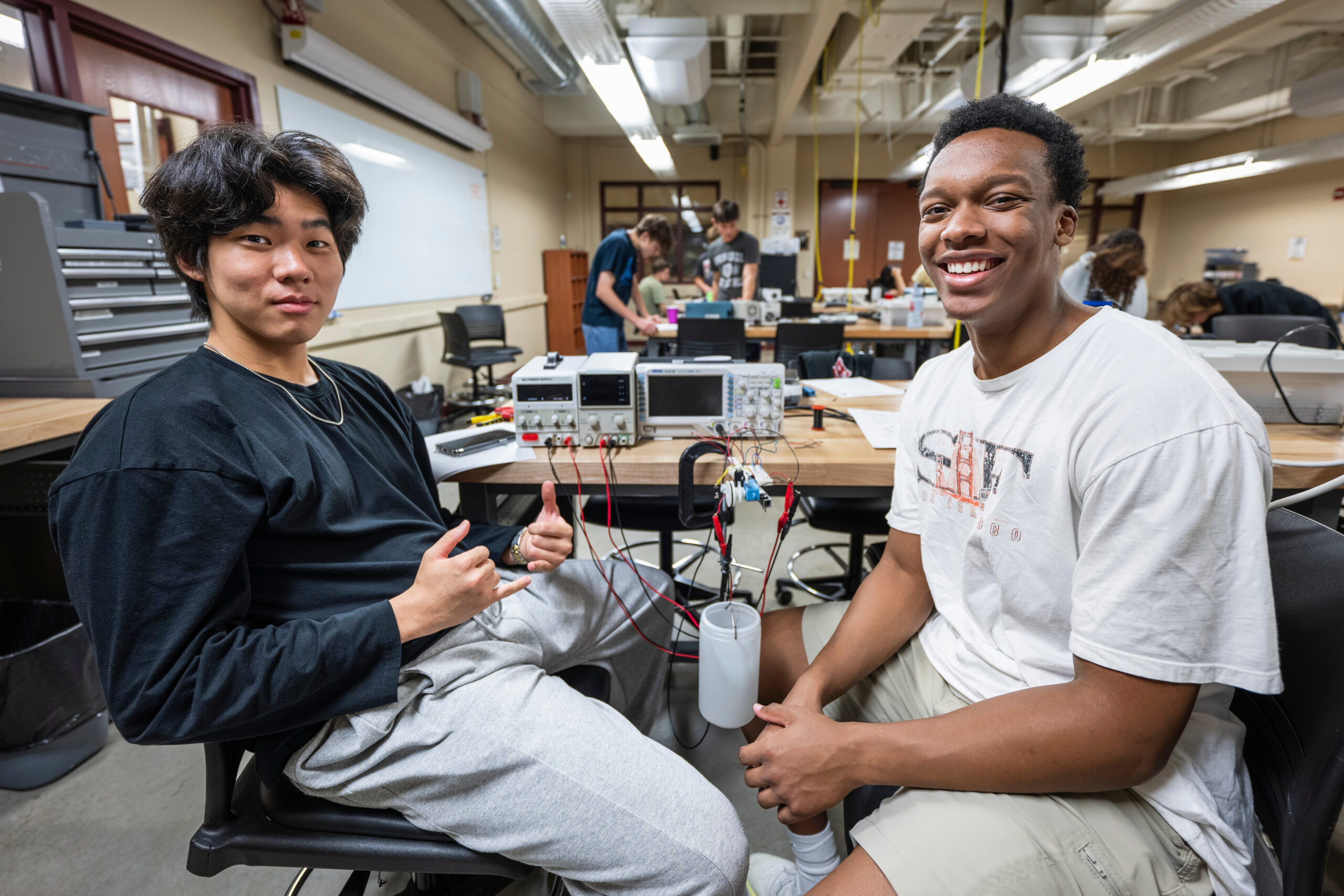 Undergraduate students are pictured in a motor measurements lab