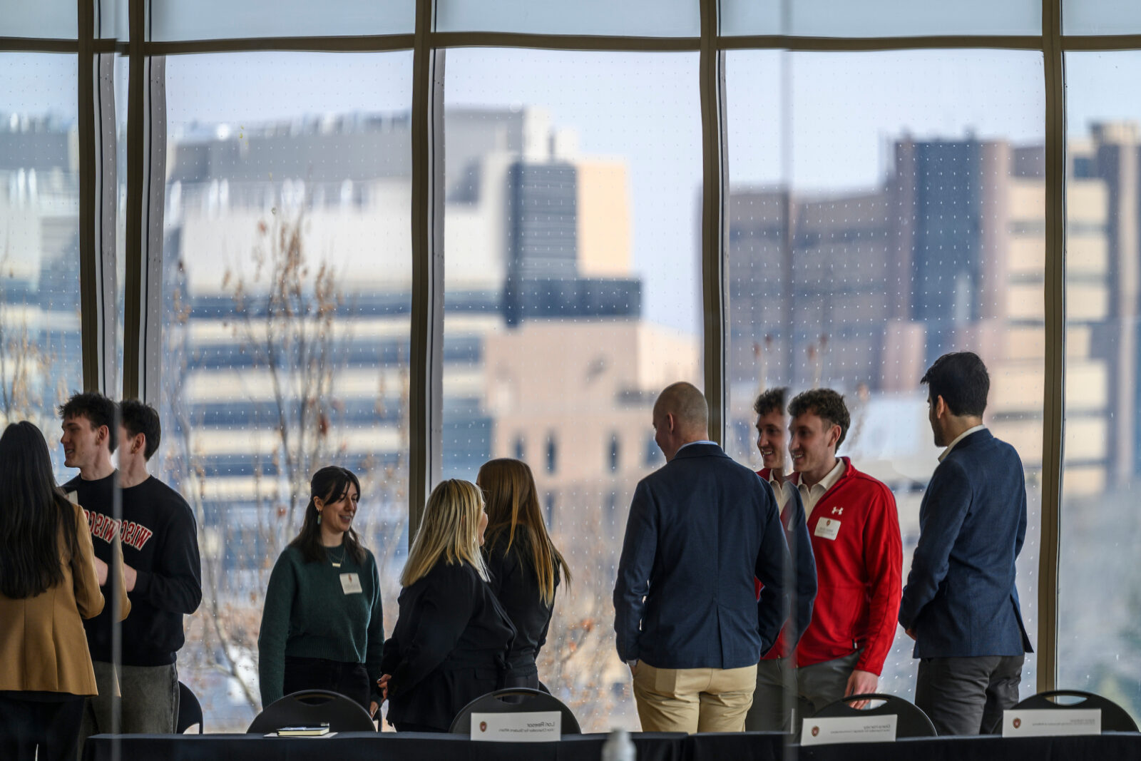 Students and Abbott staff speak before the start of the Student Wellness Presentations held in the Tempo room of the Bakke Recreation & Wellbeing Center