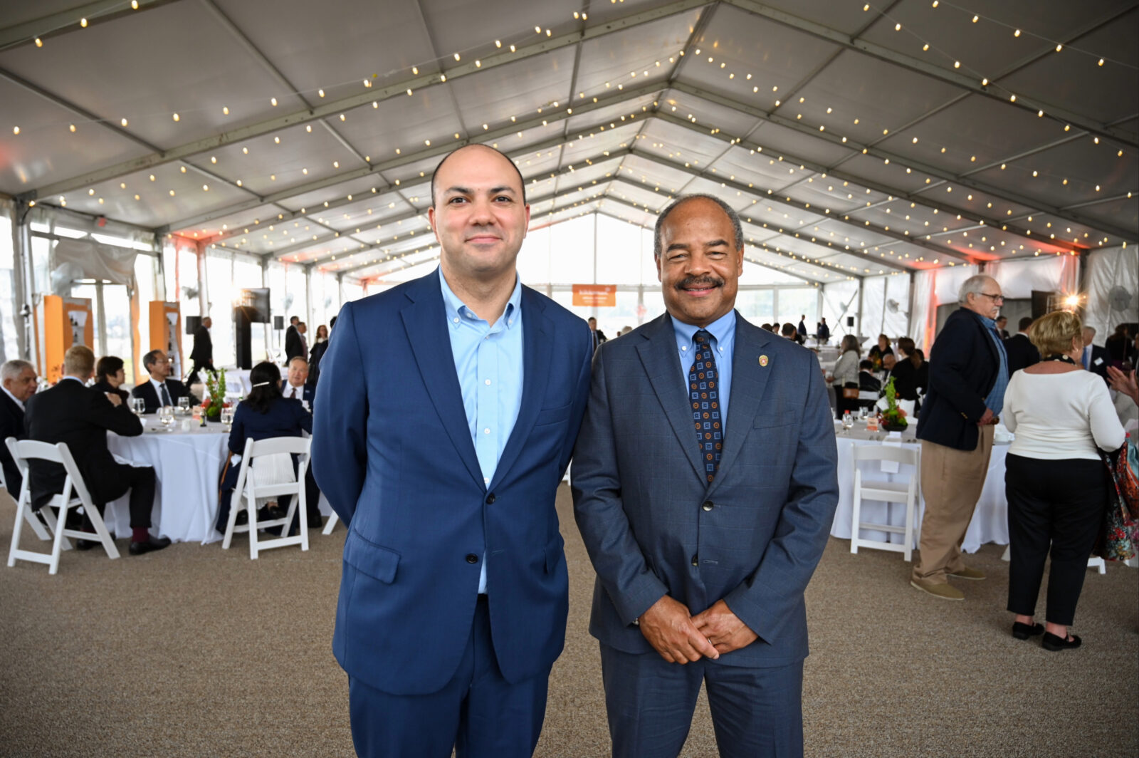John Garnetti and Eric Wilcots stand together inside the event tent.